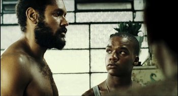 Movie still from “City of Men” (2007), directed by Paulo Morelli – Two men standing next to each other in front of a window; Close Up shot, Low angle