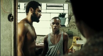 Movie still from “City of Men” (2007), directed by Paulo Morelli – Two men standing next to each other in a room; Medium shot, Low angle