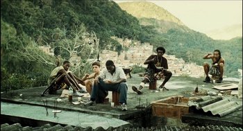 Movie still from “City of Men” (2007), directed by Paulo Morelli – A group of men sitting on top of a cement slab; Wide shot, Low angle