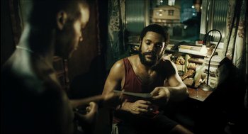 Movie still from “City of Men” (2007), directed by Paulo Morelli – Two men sitting in a room talking to each other; Medium shot, High angle