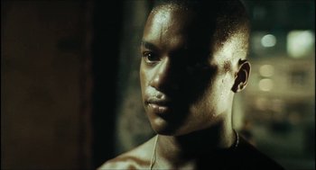 Movie still from “City of Men” (2007), directed by Paulo Morelli – A person wearing a necklace; Close Up shot, Low angle
