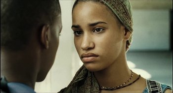 Movie still from “City of Men” (2007), directed by Paulo Morelli – A woman with a scarf on her head looking at a man with a necklace; Close Up shot, Low angle