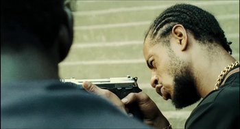 Movie still from “City of Men” (2007), directed by Paulo Morelli – A man holding a gun up to his face; Close Up shot, Over the shoulder angle