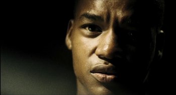 Movie still from “City of Men” (2007), directed by Paulo Morelli – A young man's face in the dark; Extreme Close Up shot, Low angle