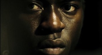 Movie still from “City of Men” (2007), directed by Paulo Morelli – A man's face in the dark; Extreme Close Up shot, Low angle
