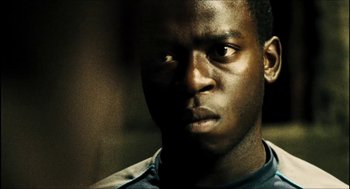 Movie still from “City of Men” (2007), directed by Paulo Morelli – A man's face in the dark; Close Up shot, Low angle