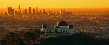 Movie still from “Day Shift” (2022), directed by J.J. Perry – A view of a city from a hill at sunset; Extreme Wide shot, High angle