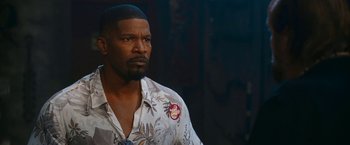 Movie still from “Day Shift” (2022), directed by J.J. Perry – A person wearing a hawaiian shirt; Close Up shot, Over the shoulder angle