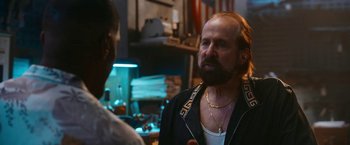 Movie still from “Day Shift” (2022), directed by J.J. Perry – A man with long hair and a beard talking to another man; Close Up shot, Over the shoulder angle