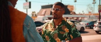 Movie still from “Day Shift” (2022), directed by J.J. Perry – A man wearing a hawaiian shirt and sunglasses; Medium shot, Over the shoulder angle