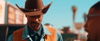 Movie still from “Day Shift” (2022), directed by J.J. Perry – A man wearing a cowboy hat and a vest; Close Up shot, Over the shoulder angle