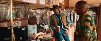 Movie still from “Day Shift” (2022), directed by J.J. Perry – A man in a cowboy hat is talking to a woman; Medium shot, Over the shoulder angle