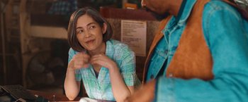 Movie still from “Day Shift” (2022), directed by J.J. Perry – A woman sitting at a table talking to a man; Close Up shot, Over the shoulder angle