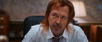 Movie still from “Day Shift” (2022), directed by J.J. Perry – A person wearing a shirt and tie; Close Up shot, Over the shoulder angle