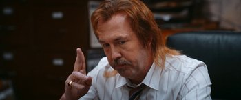 Movie still from “Day Shift” (2022), directed by J.J. Perry – A person with long red hair; Close Up shot, Over the shoulder angle