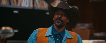 Movie still from “Day Shift” (2022), directed by J.J. Perry – A man wearing a cowboy hat and a vest; Close Up shot, Low angle