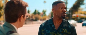 Movie still from “Day Shift” (2022), directed by J.J. Perry – A person wearing a hawaiian shirt near an elephant; Close Up shot, Over the shoulder angle