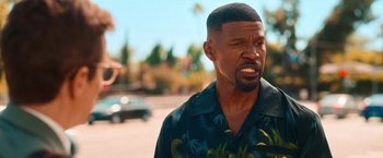 Movie still from “Day Shift” (2022), directed by J.J. Perry – A person wearing a hawaiian shirt; Close Up shot, Over the shoulder angle