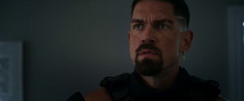 Movie still from “Day Shift” (2022), directed by J.J. Perry – A person with a beard looking at the camera; Close Up shot, Low angle