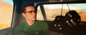 Movie still from “Day Shift” (2022), directed by J.J. Perry – A man sitting in the back seat of a car wearing glasses; Close Up shot, Over the shoulder angle