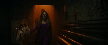 Movie still from “Day Shift” (2022), directed by J.J. Perry – A woman walking down a set of stairs in the dark; Medium shot, Low angle