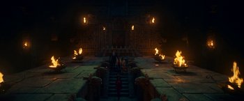 Movie still from “Day Shift” (2022), directed by J.J. Perry – A group of people sitting on steps in front of a building; Extreme Wide shot, High angle