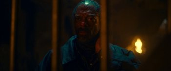 Movie still from “Day Shift” (2022), directed by J.J. Perry – A man in a jail cell looking at the camera through bars; Close Up shot, Low angle