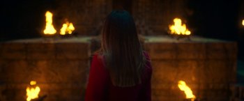 Movie still from “Day Shift” (2022), directed by J.J. Perry – A woman in a red shirt is standing in front of a fireplace; Medium shot, High angle