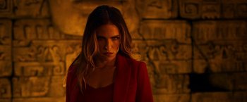 Movie still from “Day Shift” (2022), directed by J.J. Perry – A woman wearing a red jacket standing in front of a brick wall; Close Up shot, Over the shoulder angle