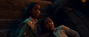 Movie still from “Day Shift” (2022), directed by J.J. Perry – Two young girls standing next to each other on steps; Close Up shot, High angle