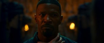 Movie still from “Day Shift” (2022), directed by J.J. Perry – A person with a hand on his neck; Close Up shot, Over the shoulder angle