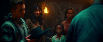 Movie still from “Day Shift” (2022), directed by J.J. Perry – A group of women and a child standing next to each other; Medium shot, Over the shoulder angle