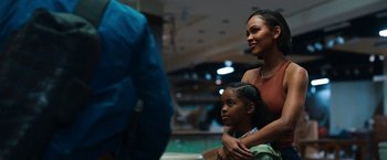 Movie still from “Day Shift” (2022), directed by J.J. Perry – A woman and a child are standing in front of a crowd; Close Up shot, Over the shoulder angle