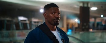 Movie still from “Day Shift” (2022), directed by J.J. Perry – A person wearing a jacket; Close Up shot, Over the shoulder angle