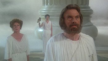 Movie still from “Clash of the Titans” (1981), directed by Desmond Davis – A man with long hair and a beard wearing a white robe; Medium shot, Low angle