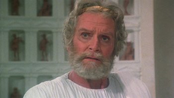 Movie still from “Clash of the Titans” (1981), directed by Desmond Davis – An old man with a beard and a white beard; Close Up shot, Low angle