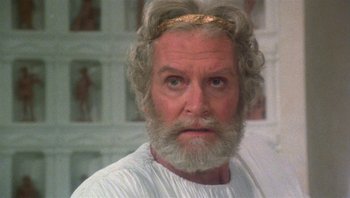 Movie still from “Clash of the Titans” (1981), directed by Desmond Davis – An older man with a beard and a crown; Close Up shot, Low angle