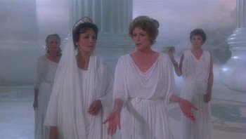 Movie still from “Clash of the Titans” (1981), directed by Desmond Davis – A group of women dressed in ancient roman clothing; Medium shot, Over the shoulder angle