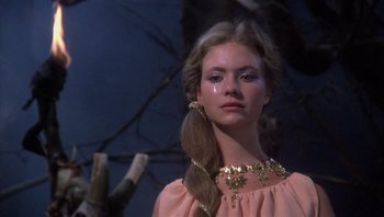 Movie still from “Clash of the Titans” (1981), directed by Desmond Davis – A young woman with long blonde hair wearing a pink dress; Close Up shot, Low angle
