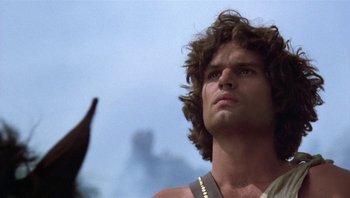 Movie still from “Clash of the Titans” (1981), directed by Desmond Davis – A man that is standing up looking up; Close Up shot, Low angle