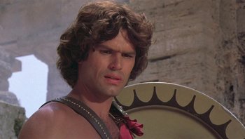 Movie still from “Clash of the Titans” (1981), directed by Desmond Davis – A person with a drum; Close Up shot, Low angle