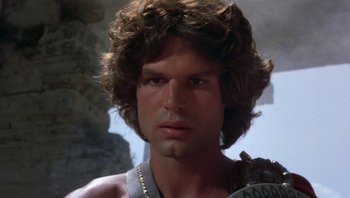 Movie still from “Clash of the Titans” (1981), directed by Desmond Davis – A man that is wearing a chain around his neck; Close Up shot, Low angle