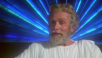 Movie still from “Clash of the Titans” (1981), directed by Desmond Davis – An old man with a beard and a crown on his head; Close Up shot, Low angle