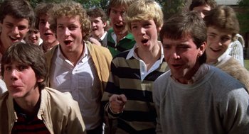 Movie still from “Class” (1983), directed by Lewis John Carlino – A group of young men standing next to each other; Medium shot, High angle