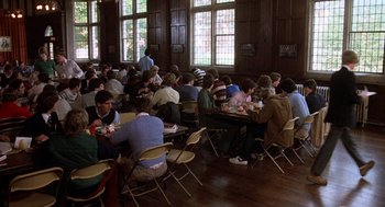 Movie still from “Class” (1983), directed by Lewis John Carlino – A group of people sitting at tables eating food; Wide shot, High angle