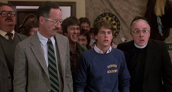 Movie still from “Class” (1983), directed by Lewis John Carlino – A group of young men standing next to each other in a room; Medium shot, Over the shoulder angle