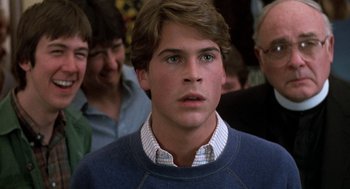 Movie still from “Class” (1983), directed by Lewis John Carlino – A young man in a crowd of people looking at the camera; Close Up shot, Over the shoulder angle