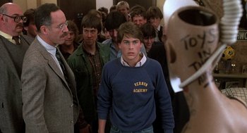 Movie still from “Class” (1983), directed by Lewis John Carlino – A group of people standing in a room; Medium shot, Over the shoulder angle