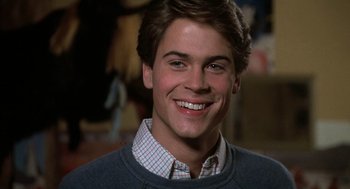 Movie still from “Class” (1983), directed by Lewis John Carlino – A young man smiles for the camera; Close Up shot, Over the shoulder angle
