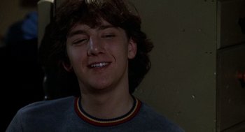 Movie still from “Class” (1983), directed by Lewis John Carlino – A person smiling with his eyes closed; Close Up shot, Low angle